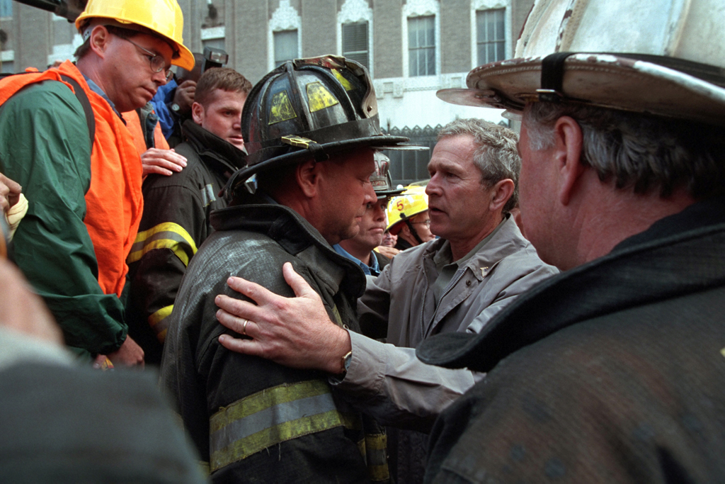 President George W. Bush embraces a firefighter at the site of the World Trade Center, September 14, 2001, during his visit to New York City. (P7371-06a)