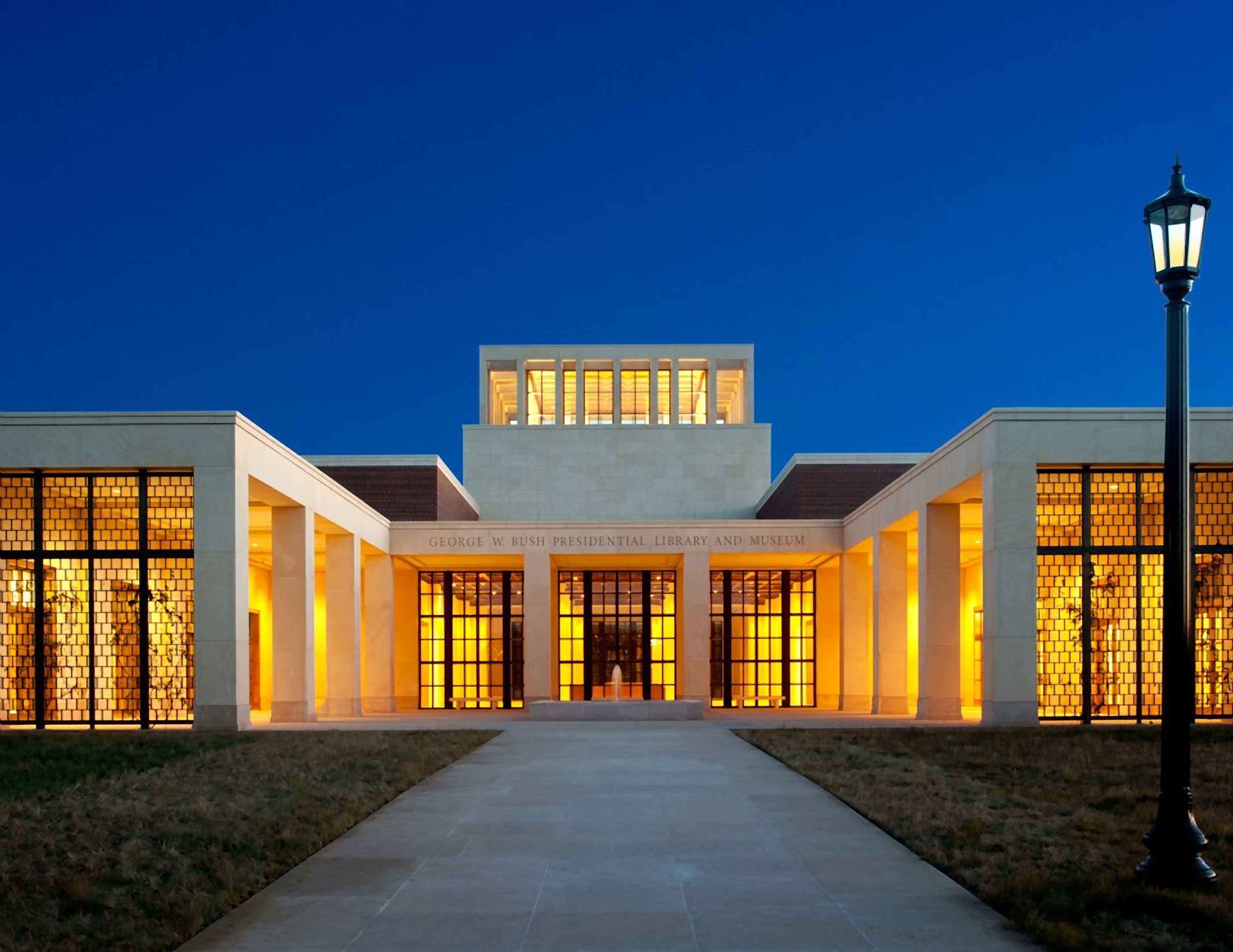 The front facade of the George W. Bush Presidential Center, as seen in the night